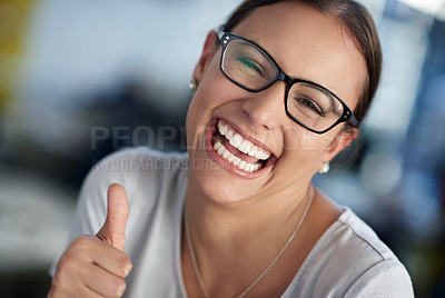 Buy stock photo Cropped portrait of a young woman smiling and giving you the thumbs up sign