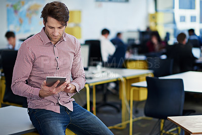 Buy stock photo Man using a digital tablet in an open plan office space