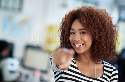 Buy stock photo Young woman pointing at the camera with open office space behind her