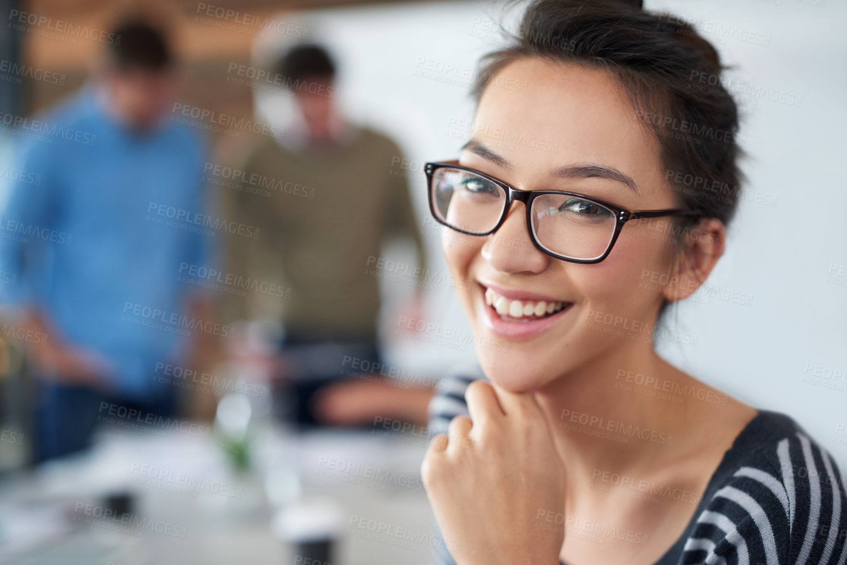 Buy stock photo Portrait of an attractive young woman sitting in an office with colleagues in the background