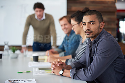 Buy stock photo Portrait of a group of coworkers sitting at a conference table