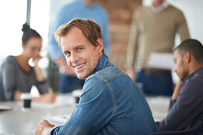 Buy stock photo Office, meeting and portrait of businessman by desk for creative company, collaboration and partnership. Smile, man and face with pride in conference for copywriting, teamwork and planning of project