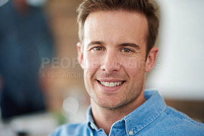 Buy stock photo Portrait of an handsome man sitting in an office with colleagues in the background