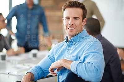 Buy stock photo Shot of a handsome young man sitting in a meeting