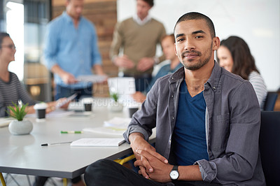 Buy stock photo Shot of a handsome young man sitting in a meeting