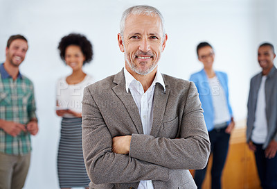 Buy stock photo Mature man standing proudly in front of his team