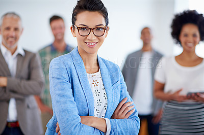 Buy stock photo Beautiful young woman smiling, with colleagues standing in the background