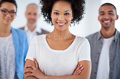 Buy stock photo Closeup portrait of a friendly businesswoman with her staff in the background
