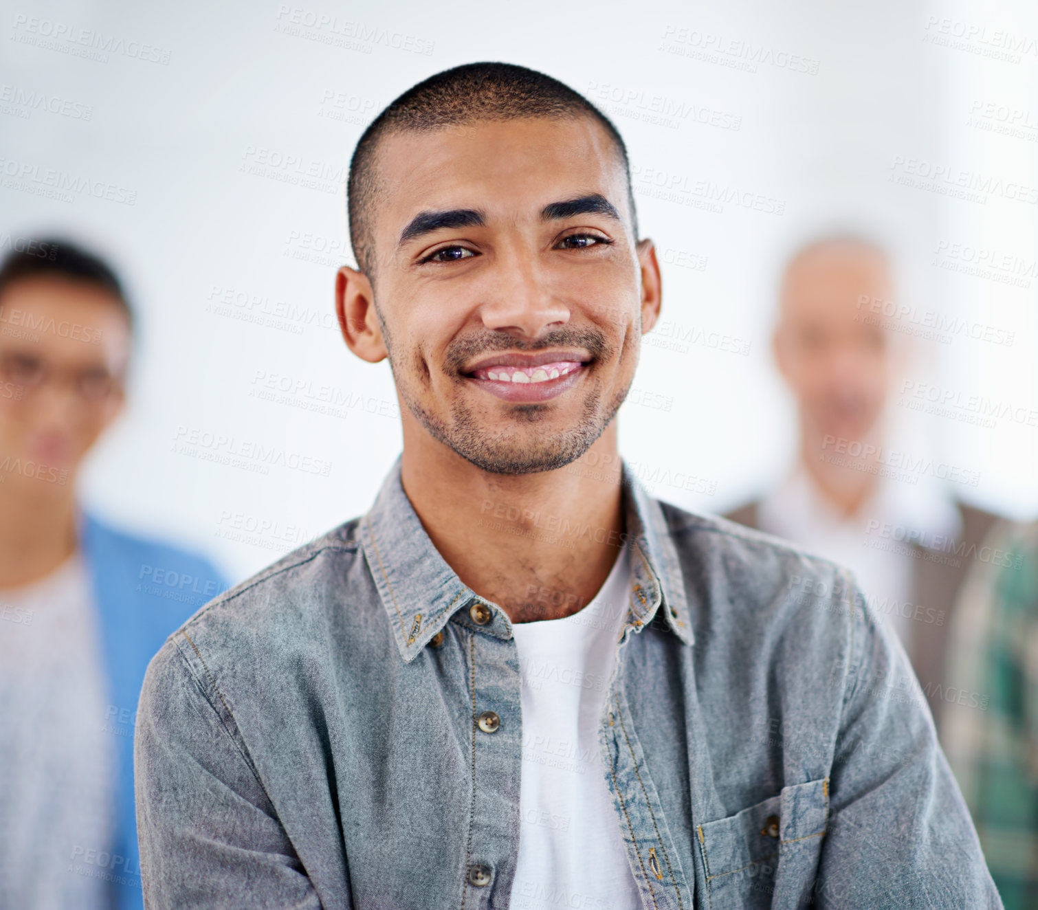 Buy stock photo Proud looking young man with people in the background