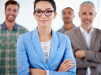 Buy stock photo Cropped portrait of a confident businesswoman with staff in the background