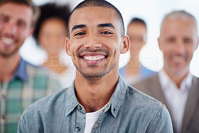 Buy stock photo Closeup of a smiling businessman with colleagues in the background