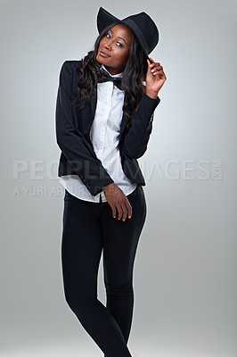 Buy stock photo Fashion, portrait and black woman in a suit in studio for edgy, elegance or chic style on grey background. Hat, clothes and African female model with cool, trendy or stylish, bowtie or outfit choice