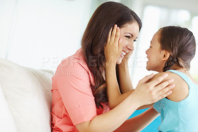 Buy stock photo Love, relax and mother with kid on sofa for bonding, security and connection at family home. Talk, smile and girl sitting on lap of mom for childhood advice, conversation or lesson in living room.