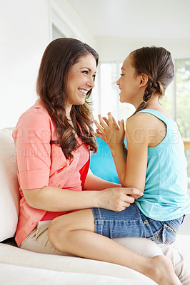 Buy stock photo Cute young mother and daughter sitting hapily together at home
