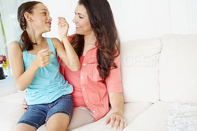 Buy stock photo Playful young mother and daughter spending time together at home