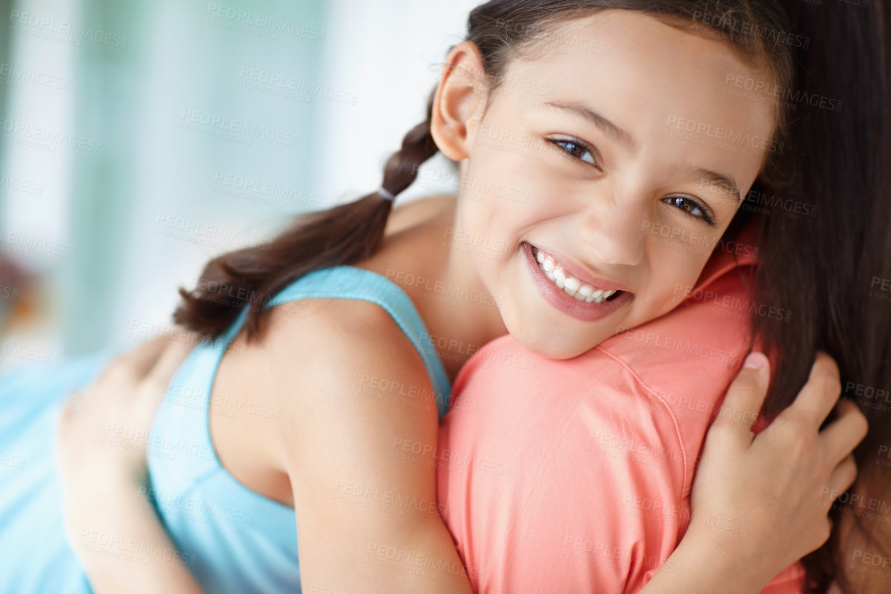 Buy stock photo Cute young mother and daughter embracing while relaxing at home