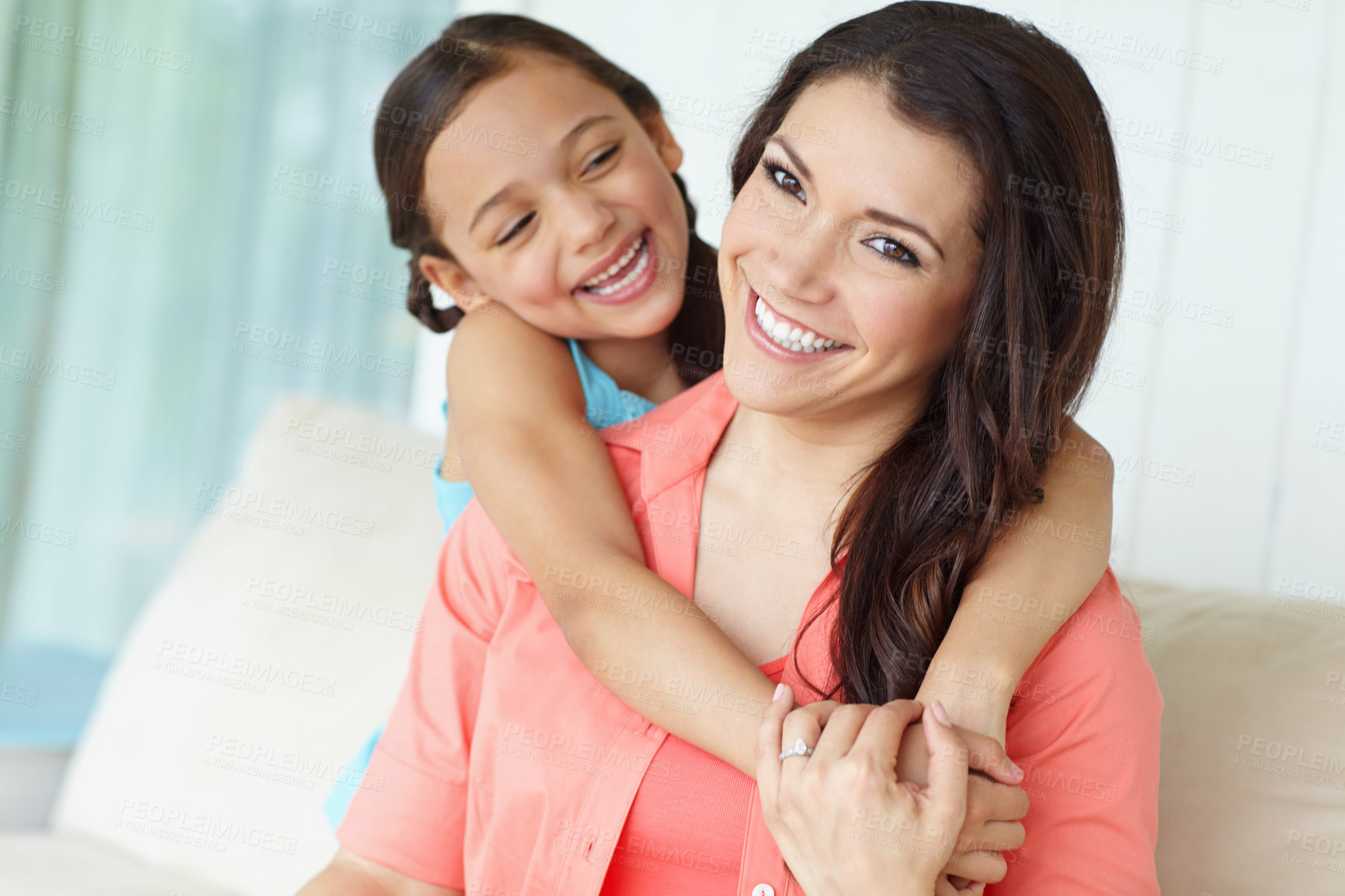Buy stock photo Portrait, woman and daughter on couch, bonding and hug in lounge, relax and mom with smile and girl. Happy family, sofa and kid with parent in living room, embrace and care for child in house