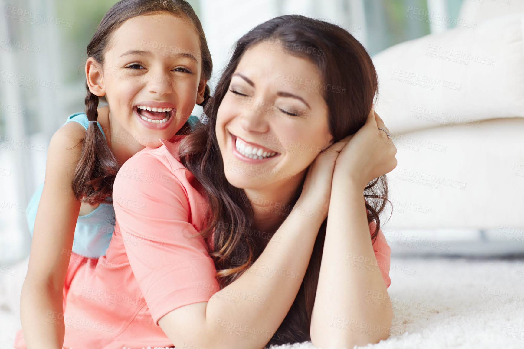 Buy stock photo Cute young mother and daughter relaxing while lying on the floor at home