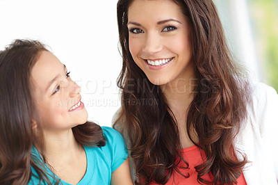 Buy stock photo Portrait of a smiling mother with her daughter looking at her with adoration