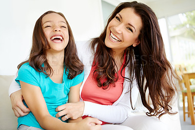 Buy stock photo A mother tickling her daugher while her daughter laughs in a moment of bonding