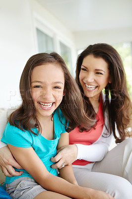 Buy stock photo A mother tickling her daugher while her daughter laughs in a moment of bonding
