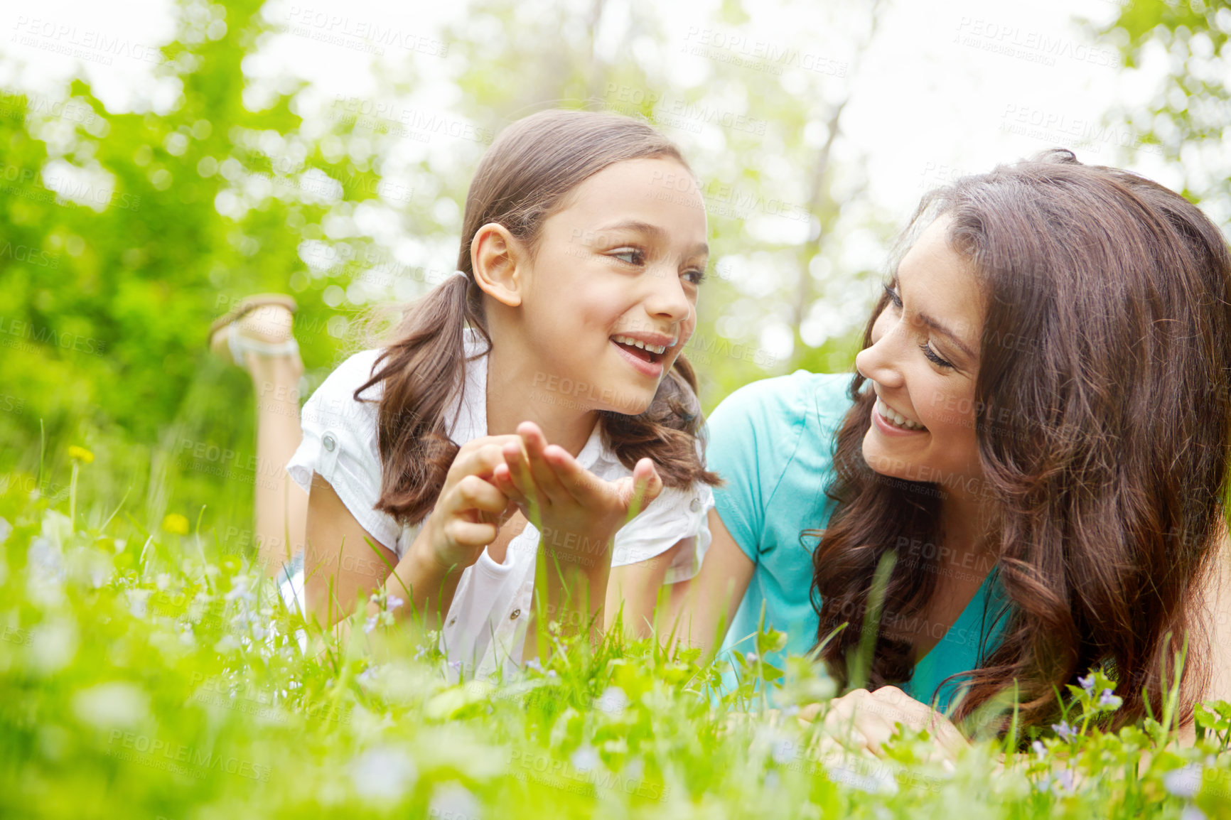 Buy stock photo Mother, girl and relax in nature, conversation and outdoor for family bonding on vacation. Mama, support daughter and countryside trip for love on weekend, laughing and lying together on holiday