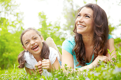 Buy stock photo A mother and daughter lying the grass of a Meadow sharing a moment