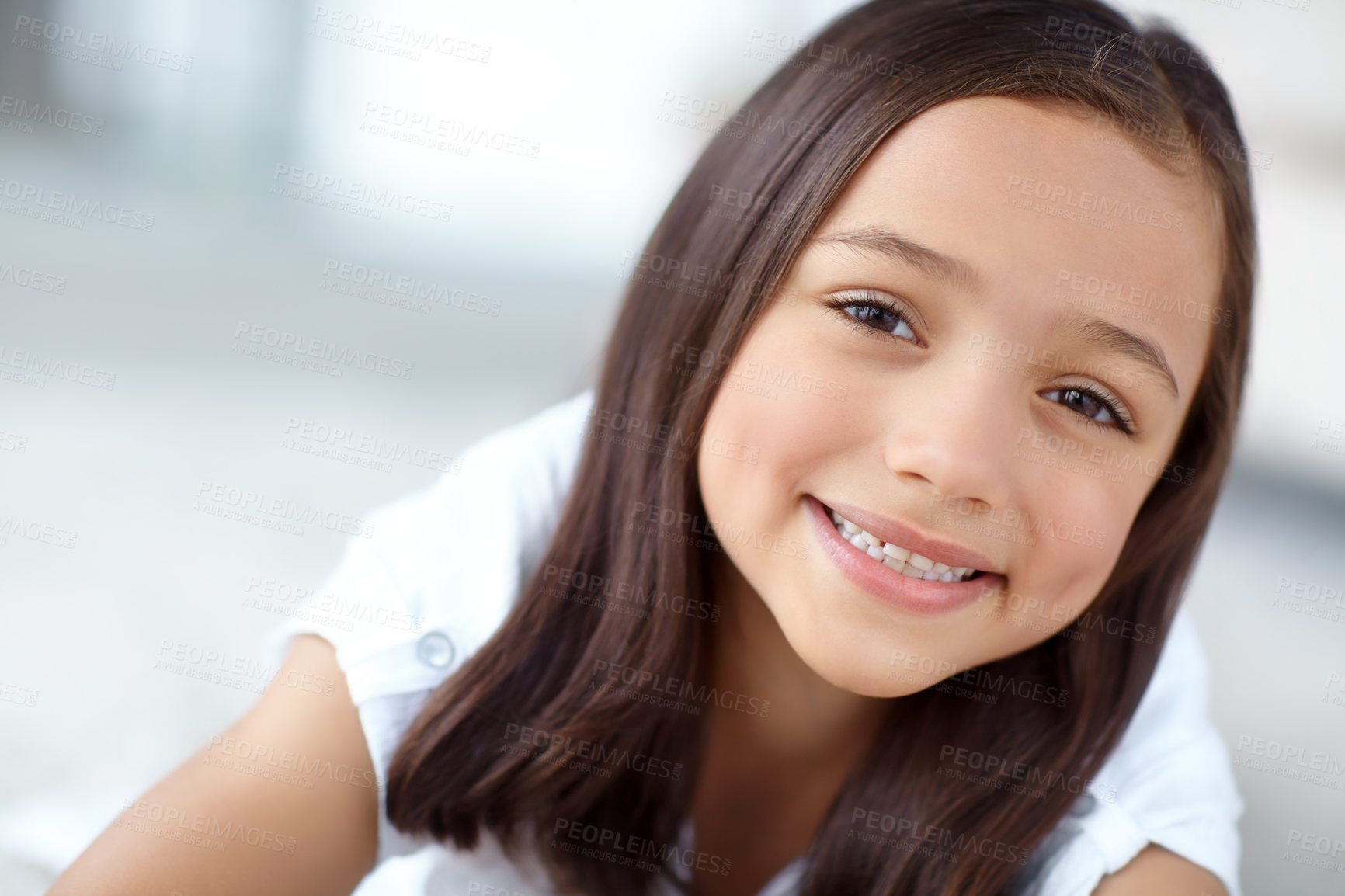 Buy stock photo Smile, playful or portrait of girl in house for joy, growth or fun in living room of home to relax. Happy, apartment or face of female kid alone for development, satisfaction or childhood in Spain