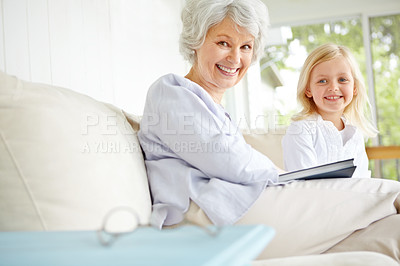 Buy stock photo Girl, senior grandmother and book on couch in home living room with woman, smile and story for retirement portrait. Happy, elderly person and weekend for rest, family and lounge for memory on sofa