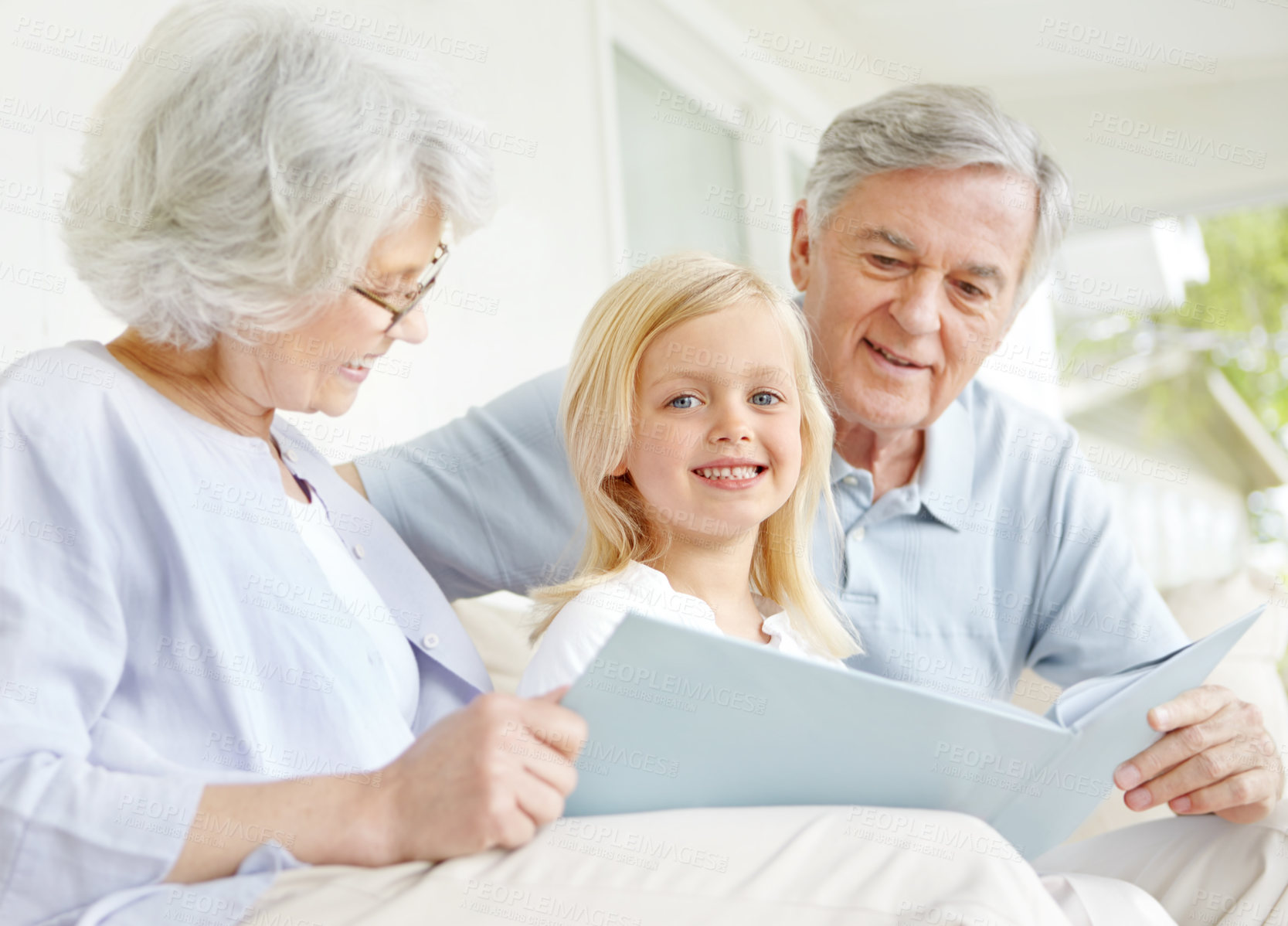 Buy stock photo Grandparents, smile and girl reading book in home for learning, bonding and knowledge together. Grandma, grandfather and kid storytelling in family house for fairytale, fantasy or child development