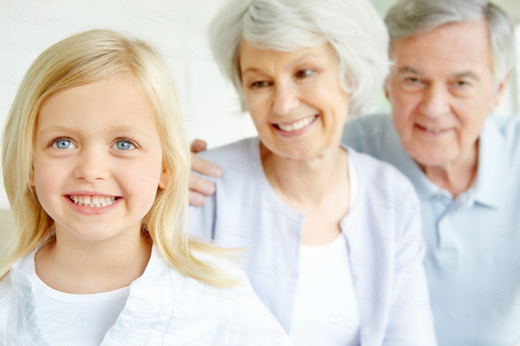 Buy stock photo Elderly man, woman and child as grandparents with happiness for bonding in family home or lounge. Senior people, little girl and together for love in living room or house for growth, support and care