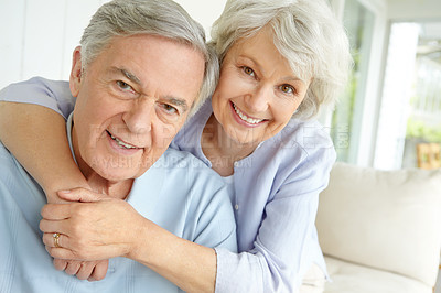 Buy stock photo Embrace, love and portrait of senior couple on sofa in living room of home together for bonding or commitment. Face, retirement or smile of old people hugging in apartment for security or trust