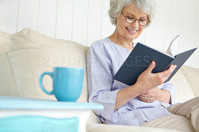 Buy stock photo Senior woman, happiness and reading book for education in retirement home on weekend on break. Elderly, female person and glasses as confident, cheerful and calm in living room on couch for knowledge