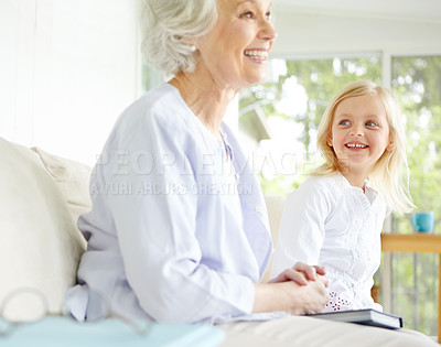 Buy stock photo Girl, senior grandma and book on couch in home living room with woman, smile and story for retirement bonding. Happy, elderly person and weekend for rest, family and house lounge for memory on sofa