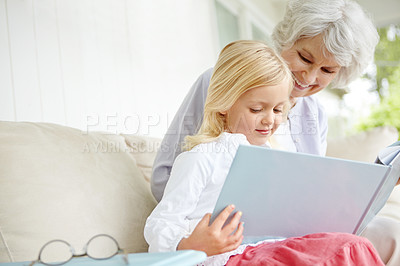 Buy stock photo Girl, elderly grandma and book in home living room with woman, smile and fantasy story for retirement bonding on sofa. Happy, senior person and weekend for rest, family and lounge for memory on couch