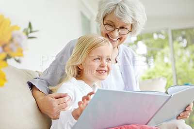 Buy stock photo Grandma, thinking and girl reading book in home for learning, bonding or knowledge together. Grandmother, senior woman and kid in family house storytelling for fairytale, fantasy or child development