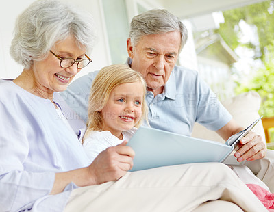 Buy stock photo Grandparents, happy and girl reading book in home for learning, bonding and knowledge together. Grandma, grandfather and kid storytelling in family house for fairytale, fantasy or child development