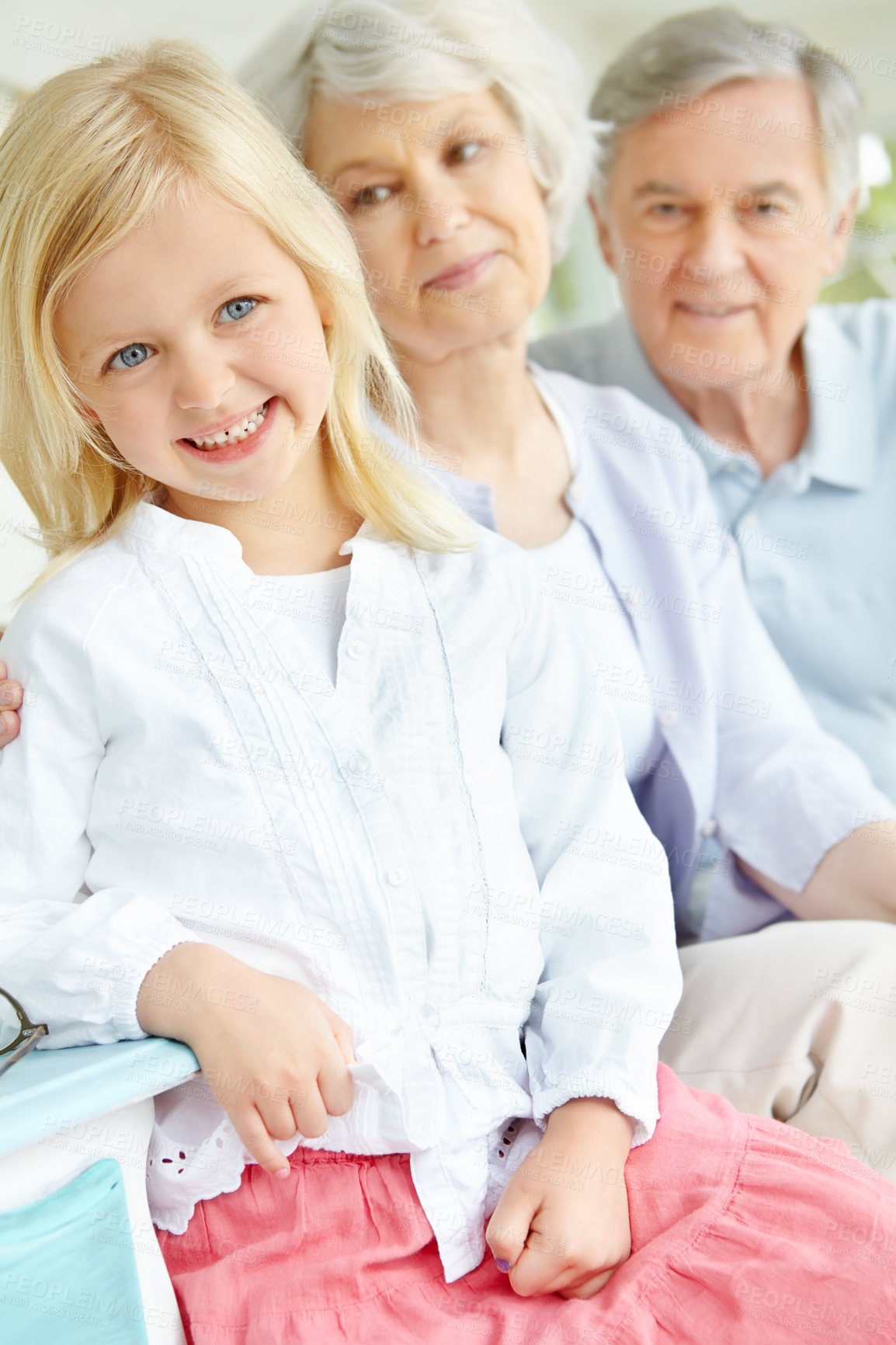 Buy stock photo Senior man, woman and child as grandparents with happiness for bonding in family home or lounge. Elderly people, little girl and together for love in living room or house for growth, support and care