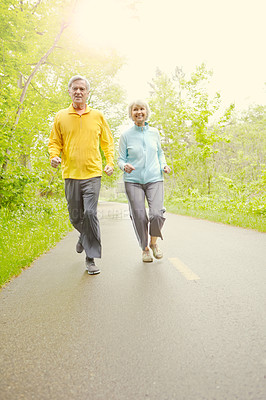 Buy stock photo Senior couple, happy and outdoor for exercise, wellness and running in nature or bonding together. Elderly people, smile and fitness in retirement for health, workout or training as pensioner in park