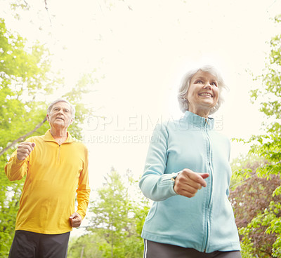 Buy stock photo Elderly couple, smile and outdoor for exercise, wellness and running in nature or bonding together. Senior people, happy and fitness in retirement for health, workout or training as pensioner in park