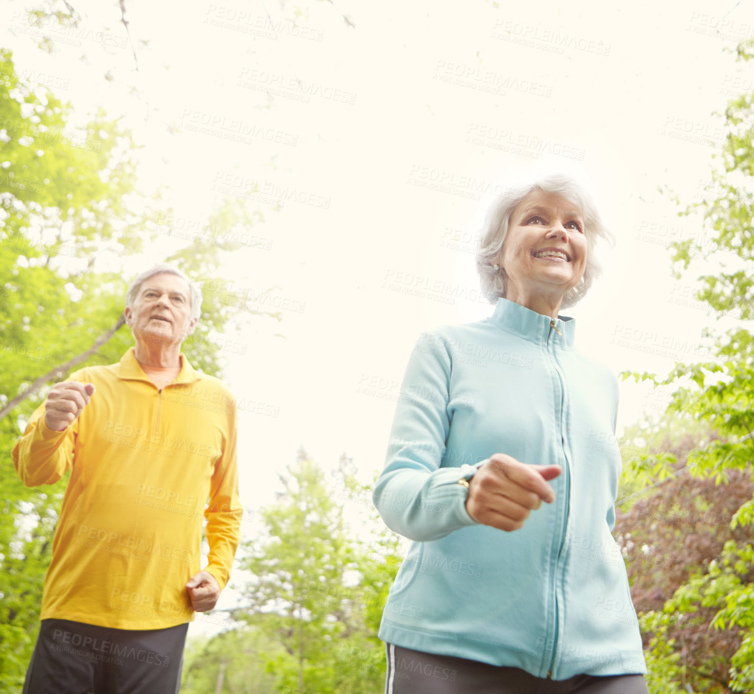 Buy stock photo Elderly couple, smile and outdoor for exercise, wellness and running in nature or bonding together. Senior people, happy and fitness in retirement for health, workout or training as pensioner in park