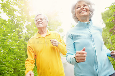 Buy stock photo Elderly couple, smile and outdoor for running, wellness or retirement in nature or bonding together. Senior people, happy and exercise in low angle for health, workout or fitness as pensioner in park