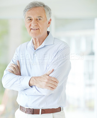 Buy stock photo Senior man, portrait and confident in home living room for retirement, health and relax with crossed arms. Elderly male, smile and healthy person on pension for positive mood, break and weekend peace