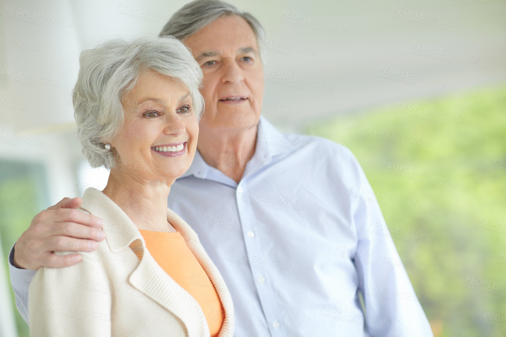 Buy stock photo Elderly couple, thinking and hug with smile in home for retirement, support or romantic connection. Happy, senior man and woman with embrace in house for marriage, bonding or love on weekend together