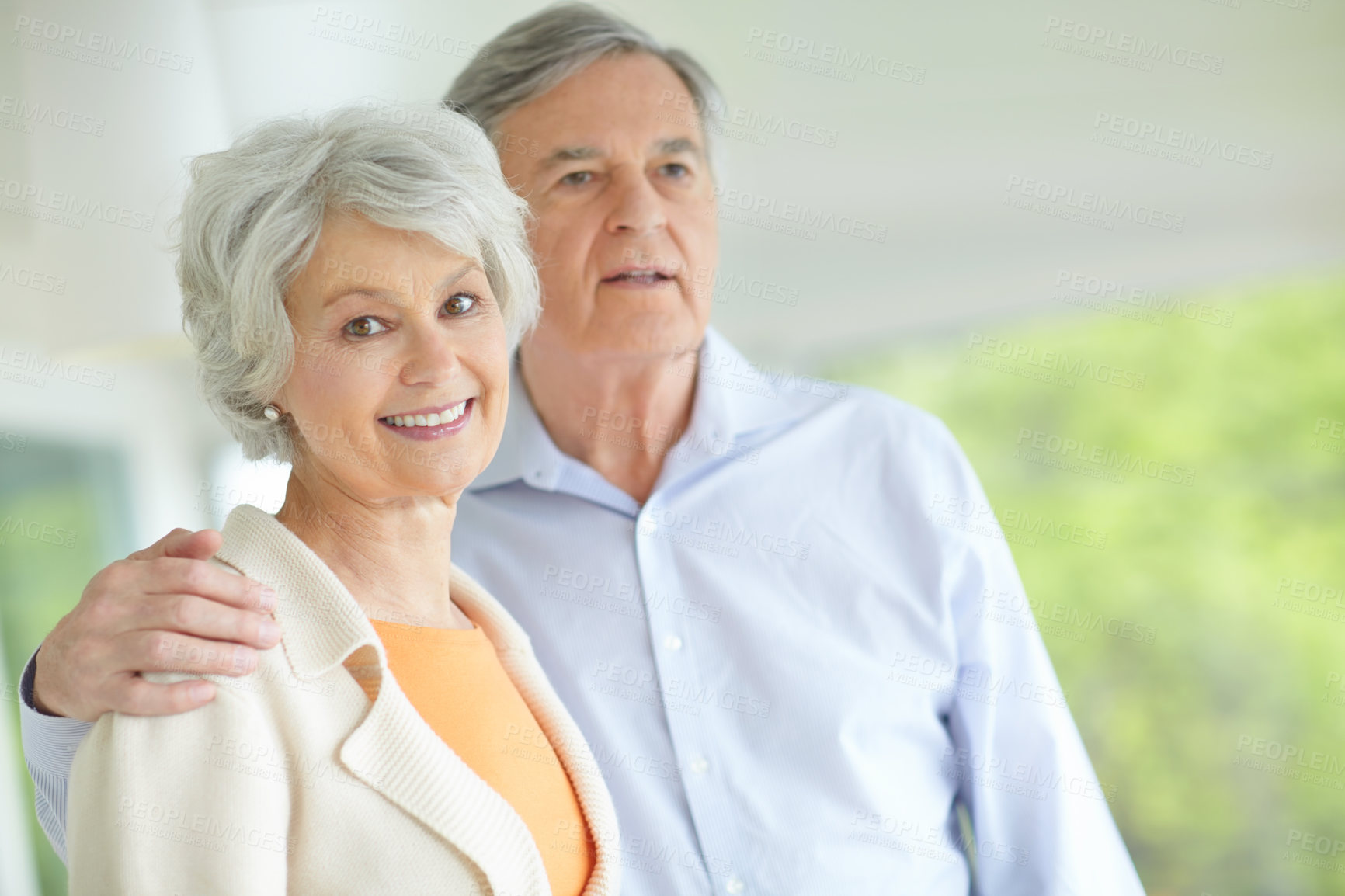 Buy stock photo Elderly couple, portrait and hug with smile in home for retirement, bonding and romantic connection. Happy, senior woman and man with love in house for marriage, support and peace on weekend together