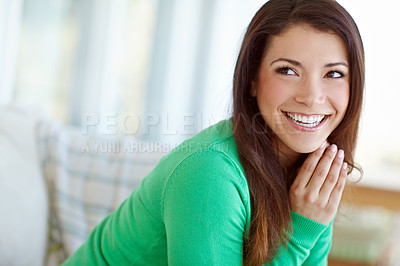 Buy stock photo An attractive young woman sitting at home