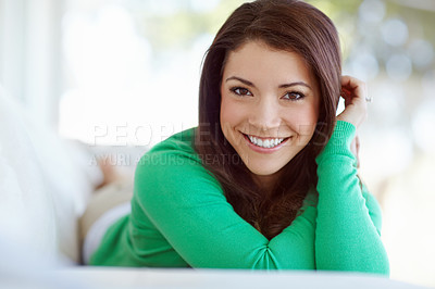 Buy stock photo Portrait of an attractive young woman lying on the sofa at home