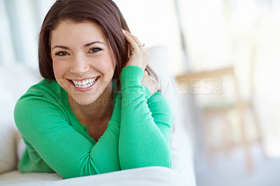 Buy stock photo Portrait of an attractive young woman lying on the sofa at home