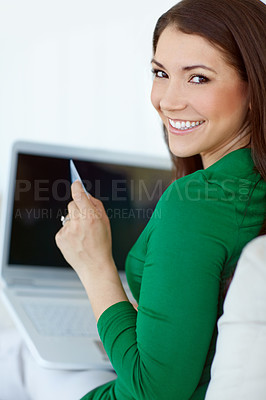 Buy stock photo Portrait of a beautiful young woman shopping online from the comfort of home