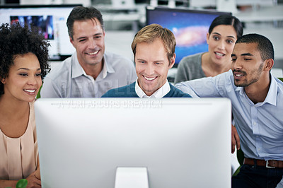 Buy stock photo Shot of a group of creative businesspeople working together on a computer in the office